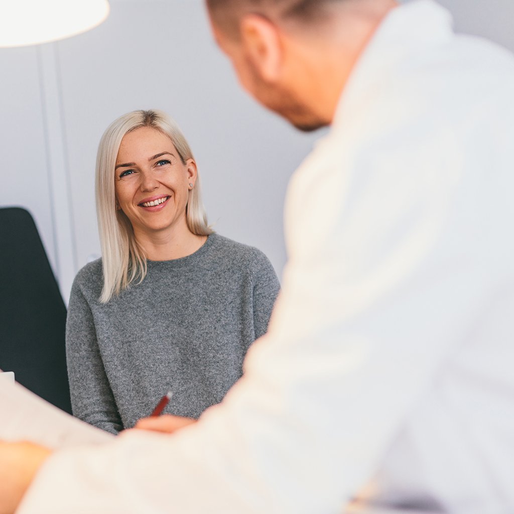 Smiling woman having a consultation with a healthcare professional
